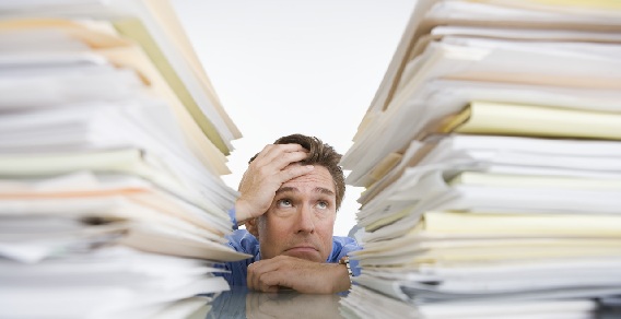 Businessman Overwhelmed with Paperwork